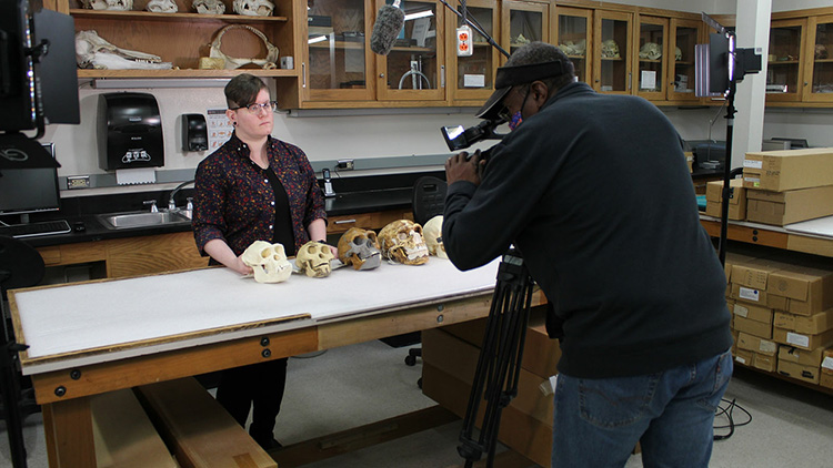 Alex Denning demonstrating changes in hominin dentition in the Laboratory of Osteology