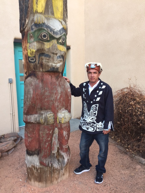 Chief Danial Smith of the Tlowitsis Nation stands with the Smith Family Totem Pole at the Maxwell Museum 2017
